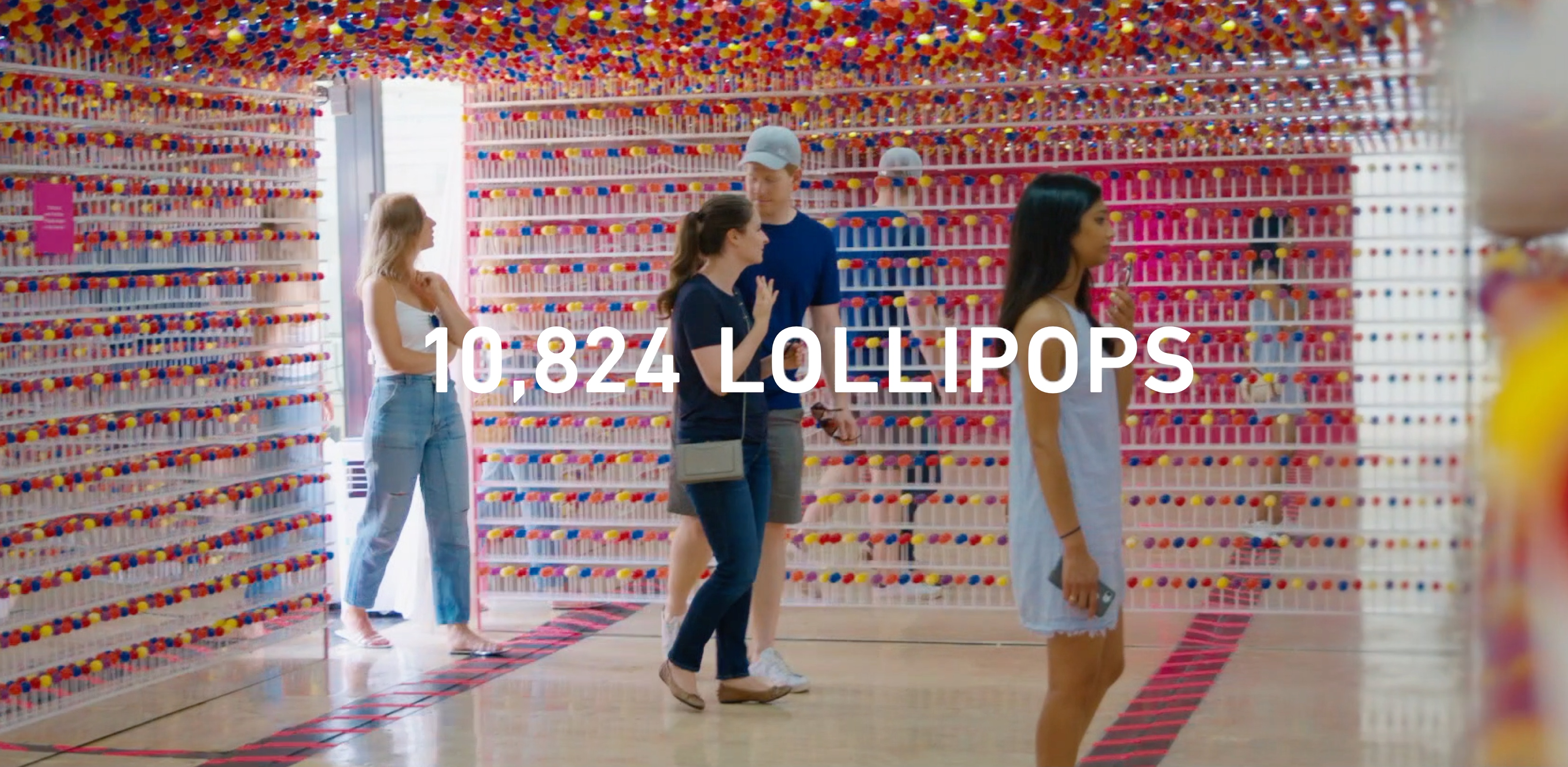 People observing the Lolli display with 10824 lollipops.